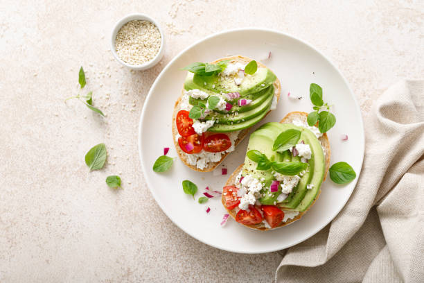 istock Avocado toast with cheese cottage, tomato and herbs for breakfast 1661426808