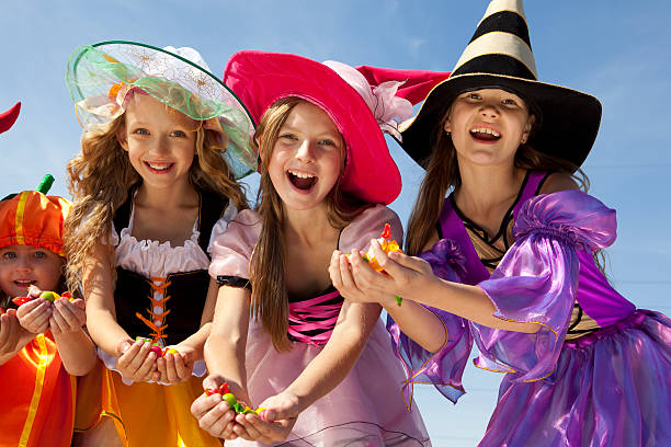 istock Four Halloween Girls Holding Candies. 166142877