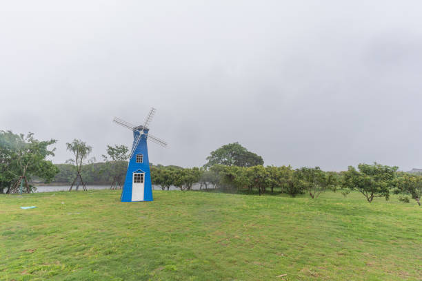 The windmill design on the green grass in the park