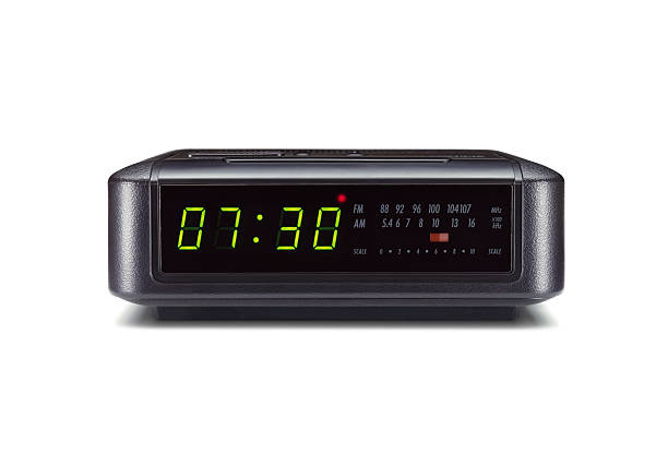 Alarm clock isolated on white background An alarm radio clock showing 7:30 isolated on white background alarm clock stock pictures, royalty-free photos & images