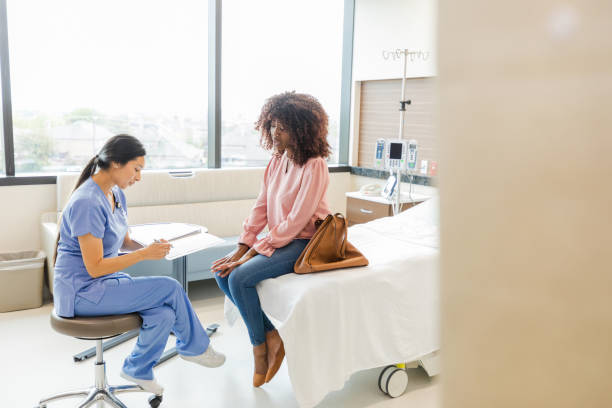 istock Doctor writes in female patient's chart 1661448798