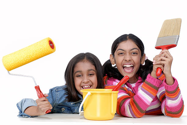 istock two girls with paint brush and roller 166145546