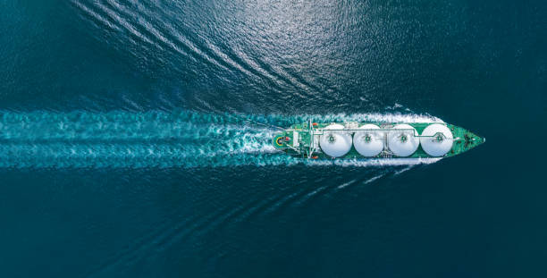 aerial top view lng tanker ship (liquified natural gas) with contrail in the ocean sea ship carrying container and running for export from container international port to custom ocean concept freight shipping by ship service - liquified petroleum gas imagens e fotografias de stock