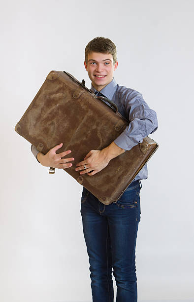 istock Young businessman embracing his old suitcase 166146262