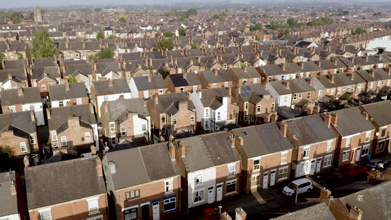 4K aerial view above rows of back to back terraced houses in the North of England