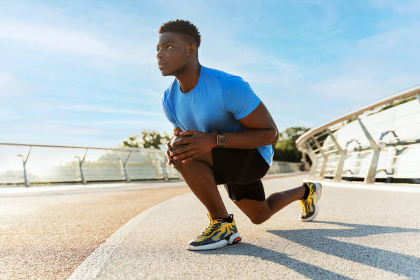 istock Young african american athlete preparing to run, stretching, looking away outdoors, summer 1661468809
