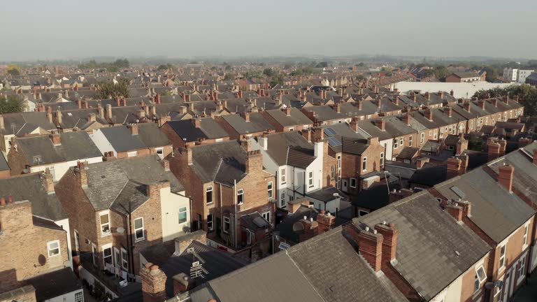 4K aerial view above rows of back to back terraced houses in the North of England