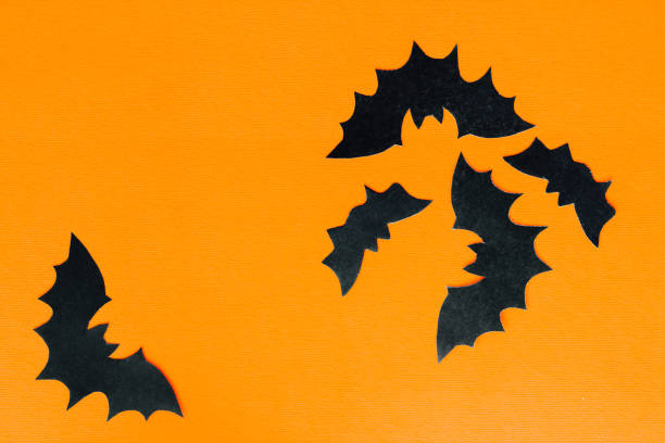istock Paper bats on an orange background, Halloween concept 1661474757