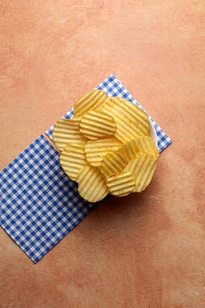 Lime Coriander potatoes chips, hand-picked potatoes that are hand selected and prepared, deep fried potatoes slices with flavors of lime and coriander, selective focus