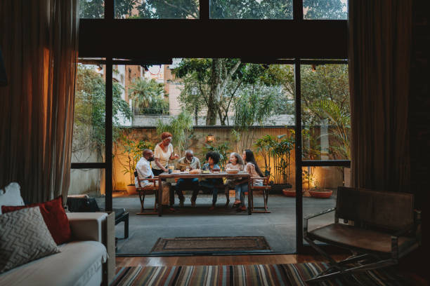 Family gathered at the table at home Family gathered at the table at home big family table stock pictures, royalty-free photos & images