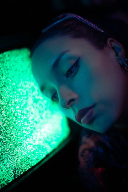 istock Young woman portrait under neon colored lights 1661475827