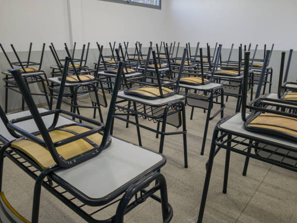 istock Empty tables and chairs in a school. Teacher strike concept. 1661477735