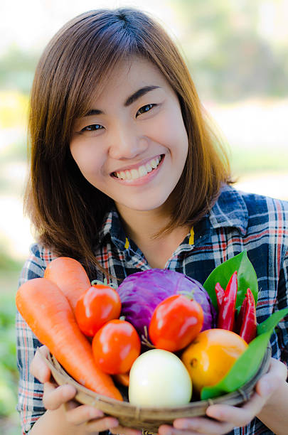istock Beautifull asian woman holding fresh vegetable bucket 166149708