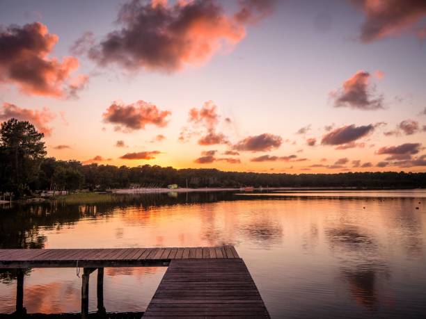 istock a dock with a few boats floating on it at sunset 1661503170