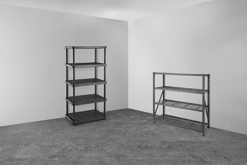 Garage room with empty metal and plastic racks & shelves