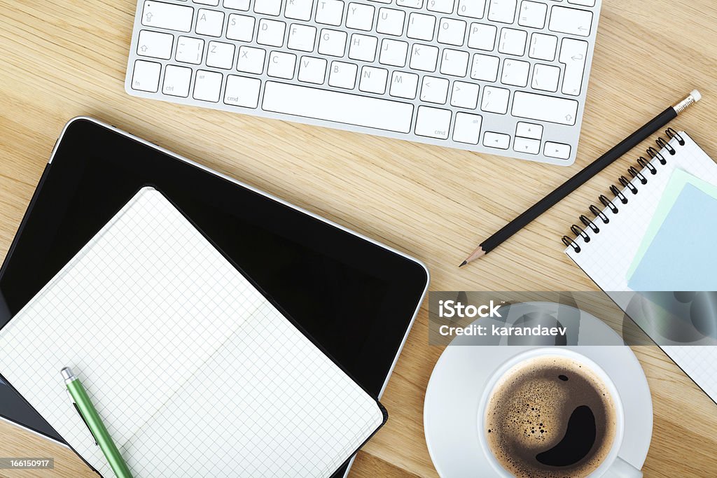 Office supplies, gadgets and coffee cup Office supplies, gadgets and coffee cup on wooden table Above Stock Photo