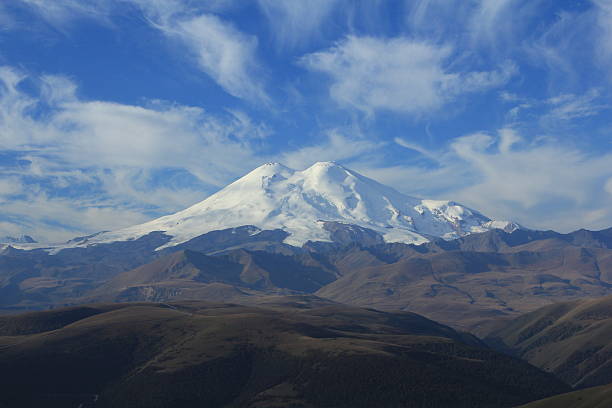 Mount Elbrus. North Caucasus In the photo Mount Elbrus, the highest mountain of the North Caucasus is represented. The photo was made at sunrise. There is an easy morning haze. The photo was made with application of a polarizing optical filter. extinct volcano stock pictures, royalty-free photos & images