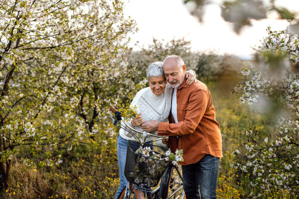 istock Senior couple enjoying walk in orchard on sunny spring day 1661515467
