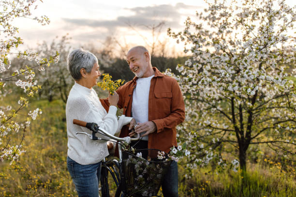 istock Senior couple enjoying walk in orchard on sunny spring day 1661515472
