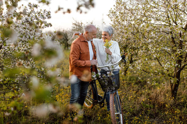 istock Senior couple enjoying walk in orchard on sunny spring day 1661515486