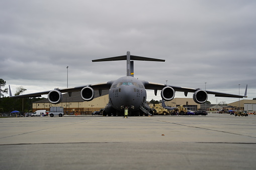 A detailed frontal view of a C-17 military aircraft, capturing the intricate design and engineering of this powerful machine.
