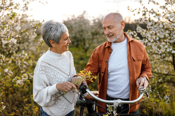 istock Senior couple enjoying walk in orchard on sunny spring day 1661516523