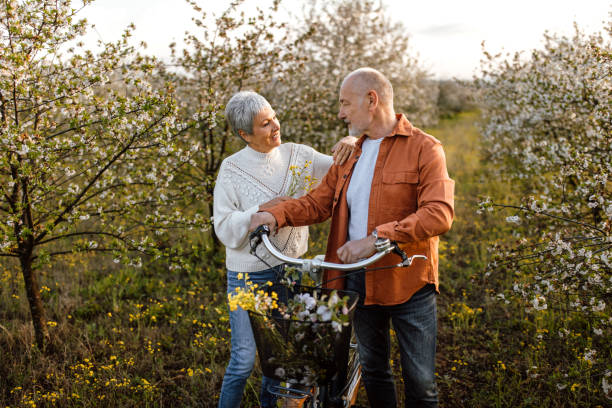 istock Senior couple enjoying walk in orchard on sunny spring day 1661516531