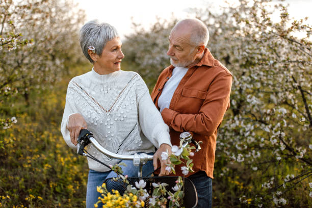 istock Senior couple enjoying walk in orchard on sunny spring day 1661516540