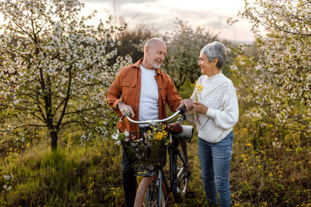 istock Senior couple enjoying walk in orchard on sunny spring day 1661517047