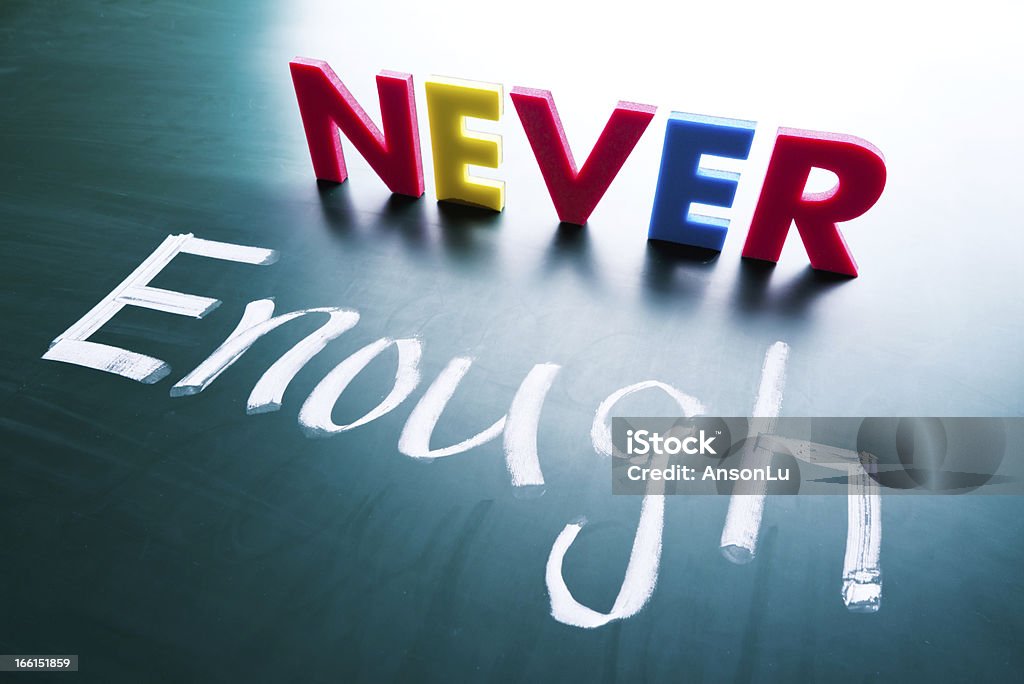 Never enough Never enough, conceptual words on blackboard Achievement Stock Photo