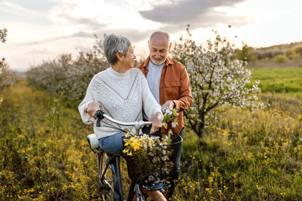 istock Active senior couple enjoying bicycle ride through cherry tree orchard 1661518706