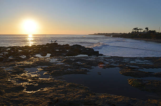 istock Ocean Sunset over Rocky Shore 166152206