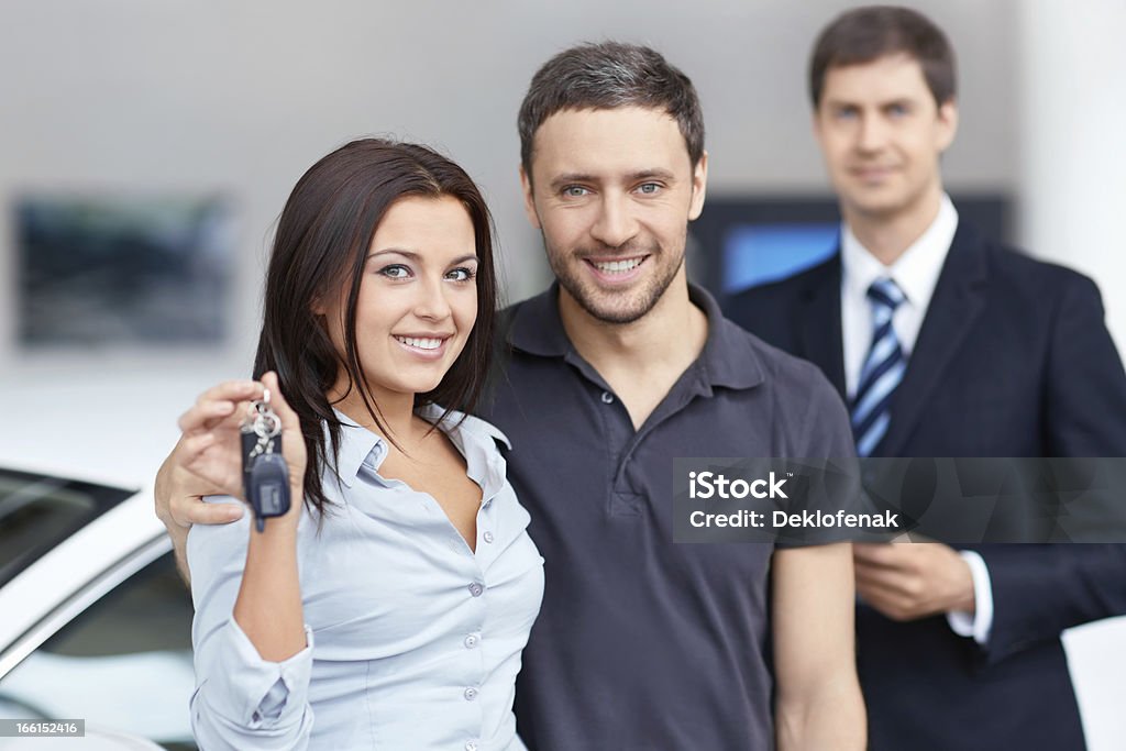 Sale of automobiles Seller and buyer in the showroom Adult Stock Photo