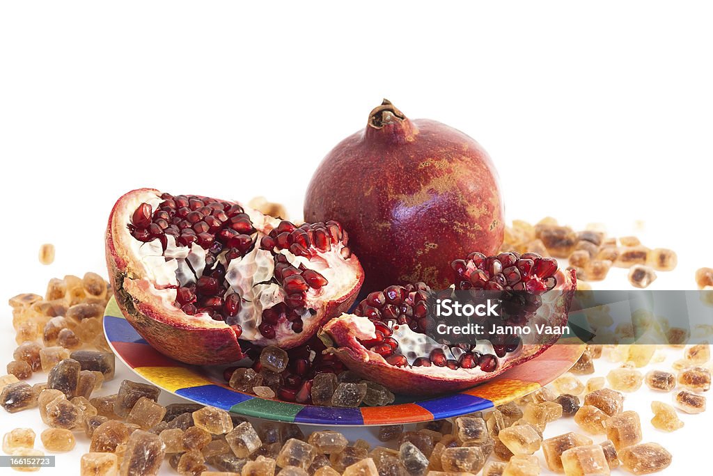 pomegranate and caramelized sugar pomegranate and brown Caramelized sugar cubes Brown Stock Photo