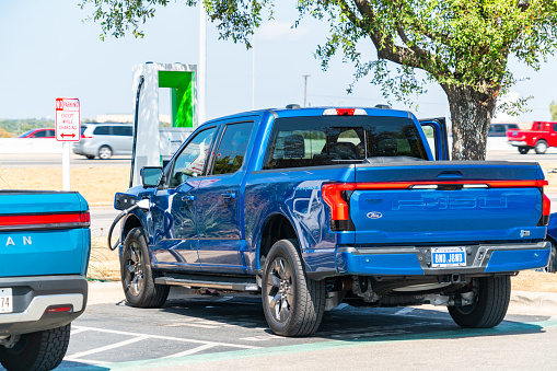 Austin , Texas , USA - September 5th 2023: Ford F150 Lightning Electric Truck charging at Electrify America Charging Station in Austin Texas