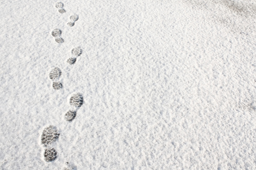 Footprints in fresh snow background great concept for winter footwear