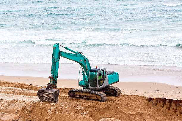 istock Bulldozer working on the beach and ocean, copy space 166153151