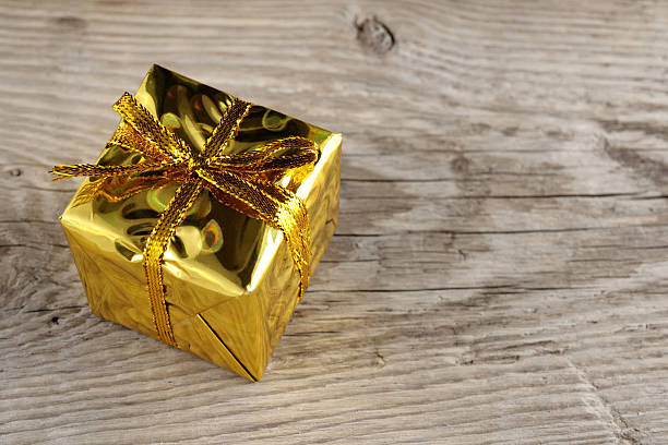 istock Golden gift box on wooden background 166153616