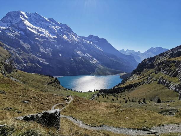 istock mountain view with water and a path leading to the mountains 1661539090