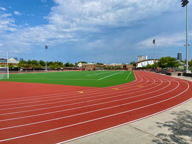 Outdoor track around an astro-turf playing field at Denny Farrell Riverbank State Park in West Harlem, New York City Eight-lane red outdoor track surrounding a green astro-turf football and soccer playing field at Denny Farrell Riverbank State Park on a summer day in West Harlem, New York City harlem park stock pictures, royalty-free photos & images