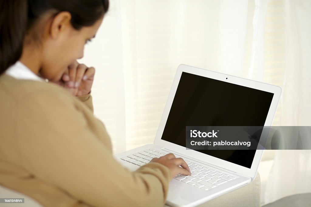 Charming young woman reading on laptop screen Portrait of a charming young woman reading on laptop screen Adult Stock Photo