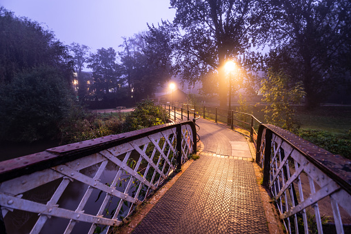 Early morning fog in Guildford River Way footbridge Surrey England Europe