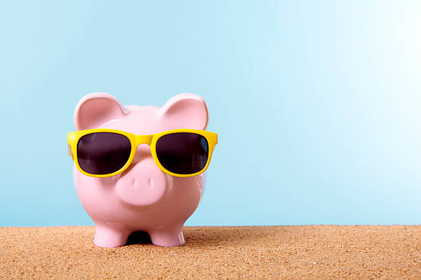 Piggy Bank on beach vacation stock photo