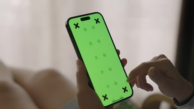 Woman hands hold smart phone with green screen display, Close-up