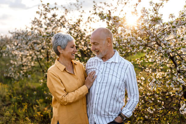 istock Senior couple enjoying walk in orchard in sunset 1661570045