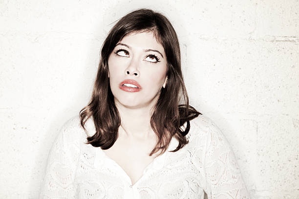 Portrait of a beautiful young woman with a very peculiar cross-eyed sneering facial expression.