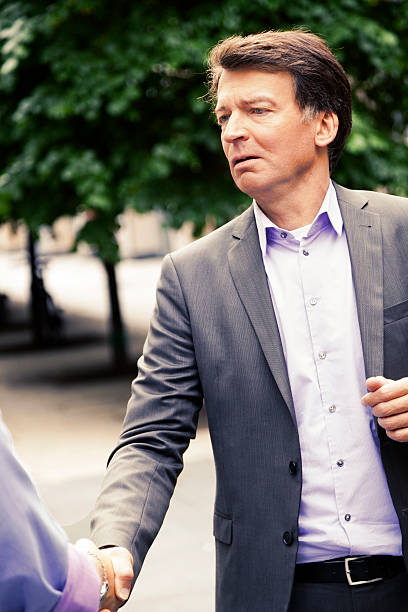 istock Mature Businessman Shaking Hands 166158616