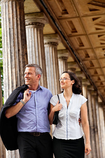 istock Elegant Couple Walking in Columns Passage 166159216