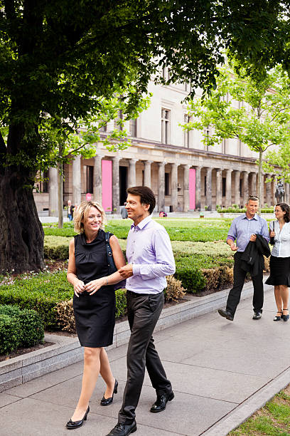 istock Two Elegant Couples Walking in Urban Garden 166159343
