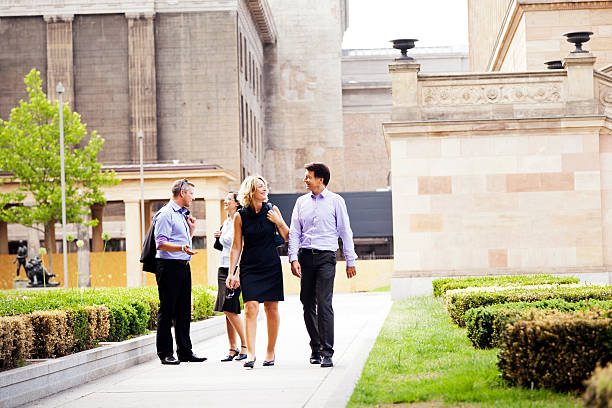 istock Two Elegant Couples Walking in Urban Garden 166159383